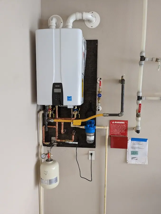 Professional plumber installing copper piping in a Queen Creek home